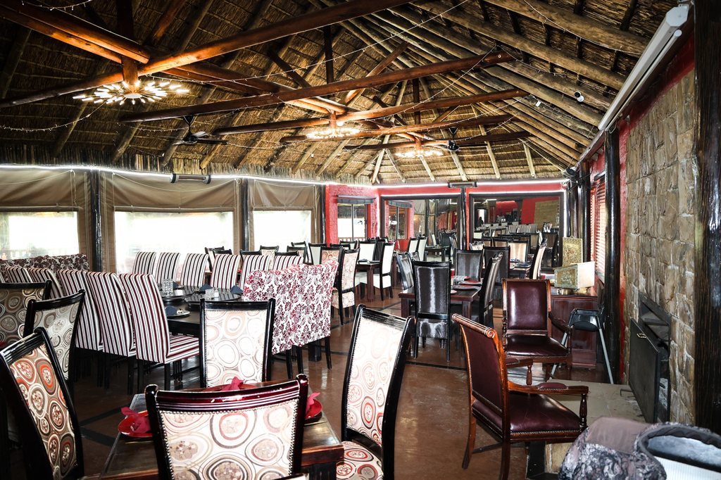 The Goldfields dining room set for service beneath its thatched roof.