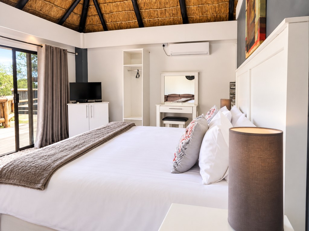 A Sandstone Room seen from the foot of the bed, with the self-catering kitchenette alongside.