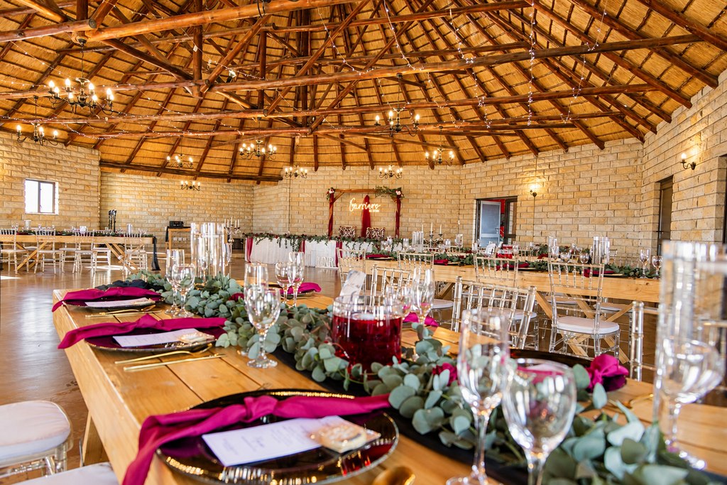 The thatched reception lit warmly for the evening, tables laid and candles burning.